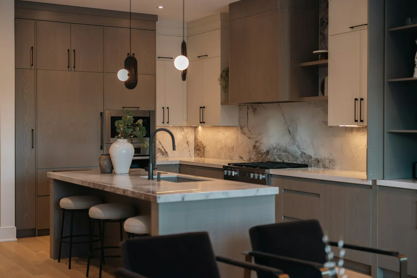 Marble backsplash behind a range in a modern kitchen