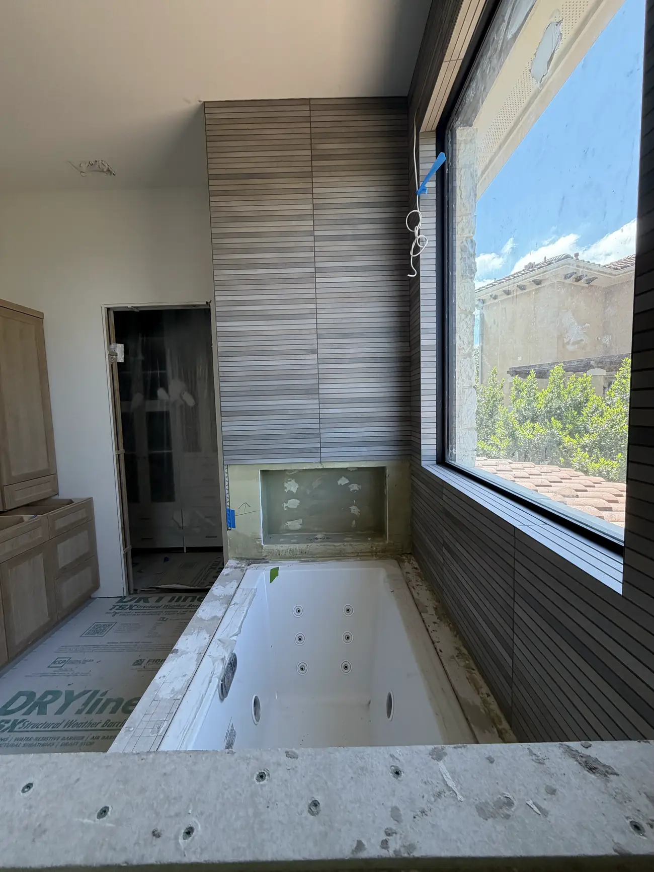 Bathroom renovation with grey tile, skylight, and a new vanity in Austin