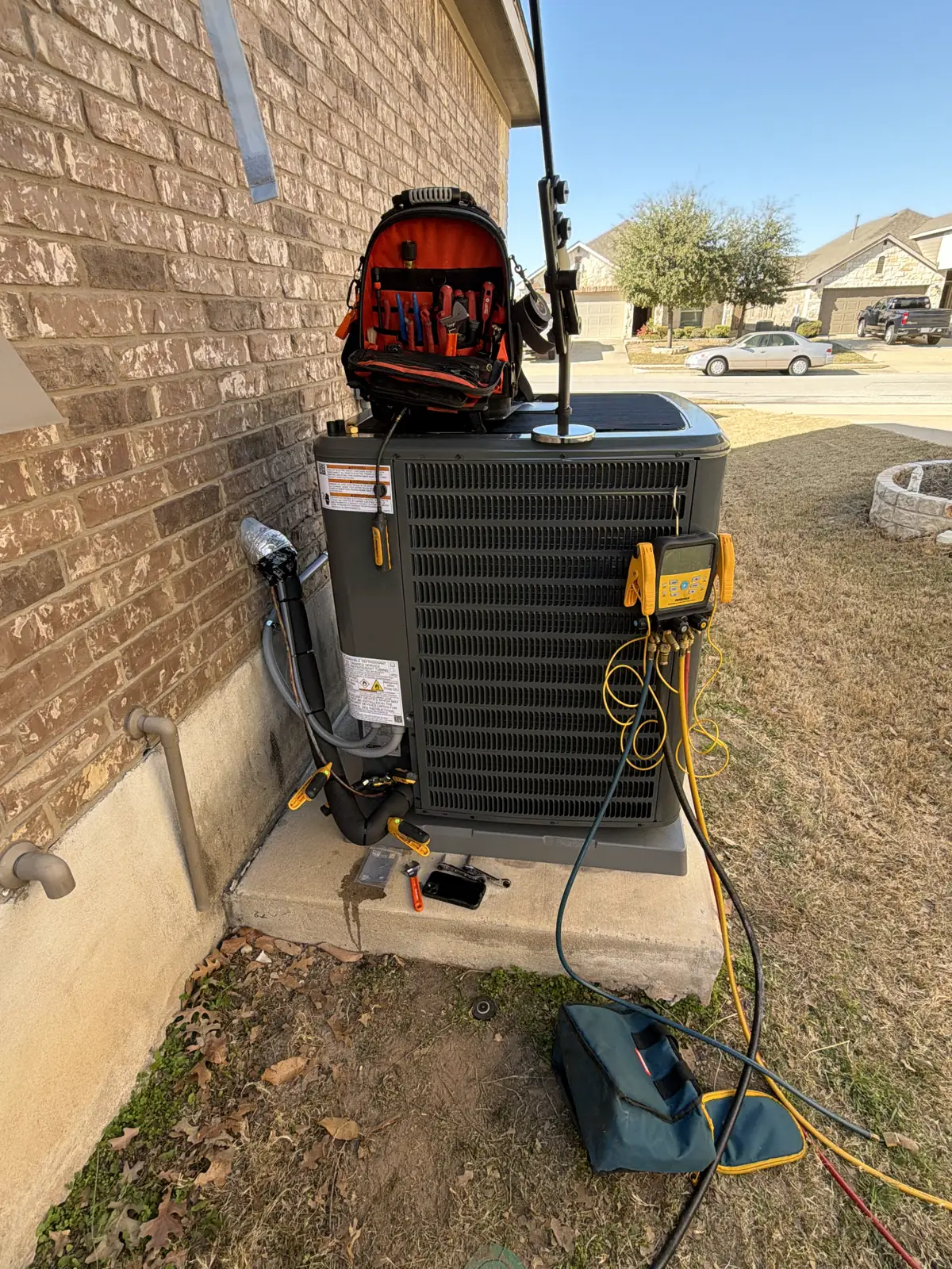 H&H Pro Services servicing an outdoor AC condenser in Austin