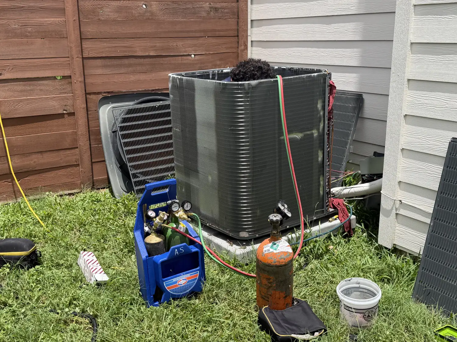 H&H Pro Services technician repairing an air conditioning condenser in Austin, TX