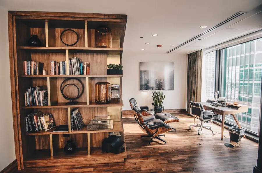 Custom walnut built-in shelving in a warm modern study