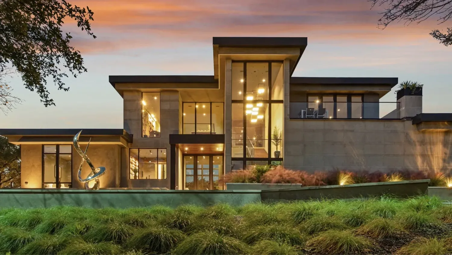 Modern luxury Austin home glowing at dusk